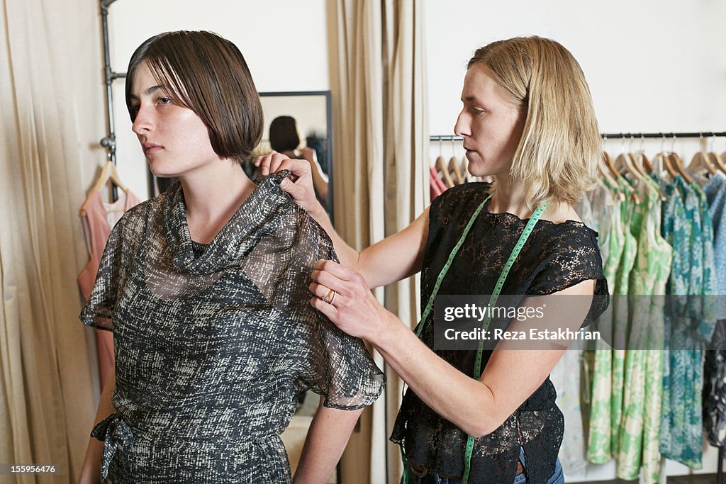 Designer adjusts fit of dress