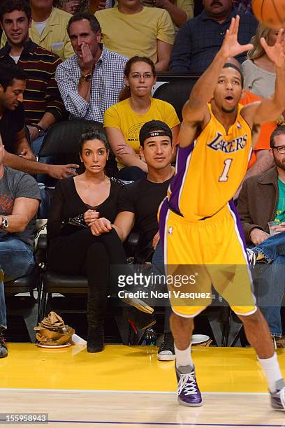 Courtney Laine Mazza and Mario Lopez attend a game between Golden State Warriors and the Los Angeles Lakers at Staples Center on November 9, 2012 in...