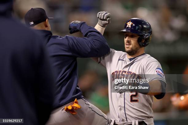 Alex Bregman of the Houston Astros is congratulated by teammates after he hit a home run against the Oakland Athletics in the ninth inning at...