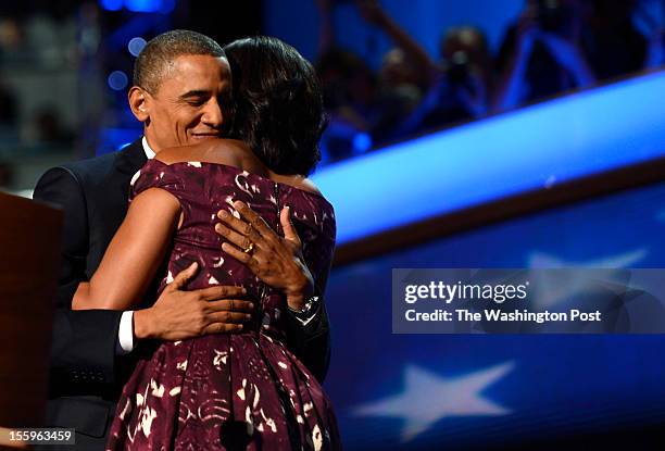 First lady Michelle Obama hugs President Barack Obama after introducing him before his nomination acceptance speech during the final night of the...