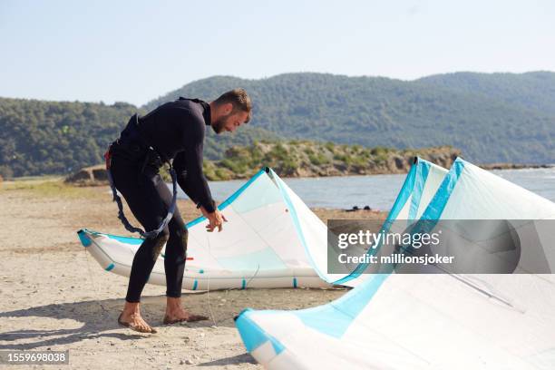 kitesurflehrer am strand vorbereitungen treffen - kite surf stock-fotos und bilder