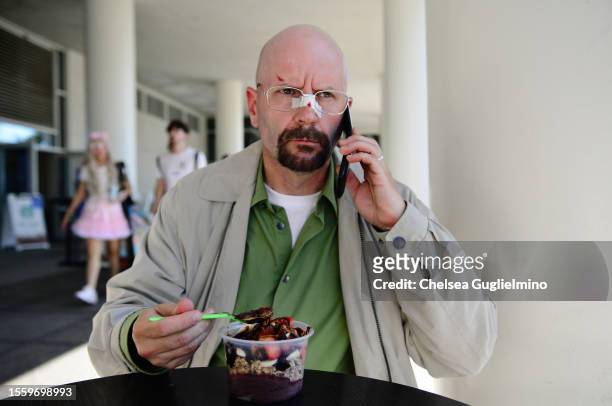 Cosplayer dressed as Walter White from "Breaking Bad" eats an acai bowl at 2023 Comic-Con International: San Diego on July 20, 2023 in San Diego,...