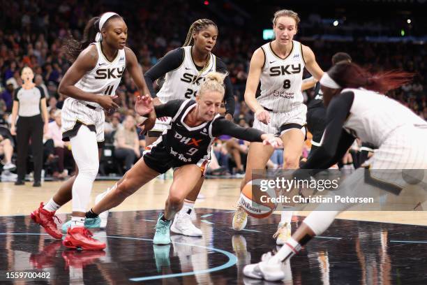 Sophie Cunningham of the Phoenix Mercury reaches for a loose ball against Kahleah Copper of the Chicago Sky during the second half of the WNBA game...