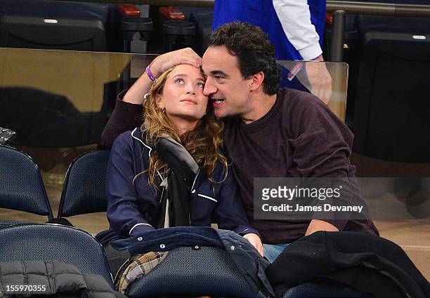 Mary-Kate Olsen and Olivier Sarkozy attend the Dallas Mavericks vs New York Knicks game at Madison Square Garden on November 9, 2012 in New York City.