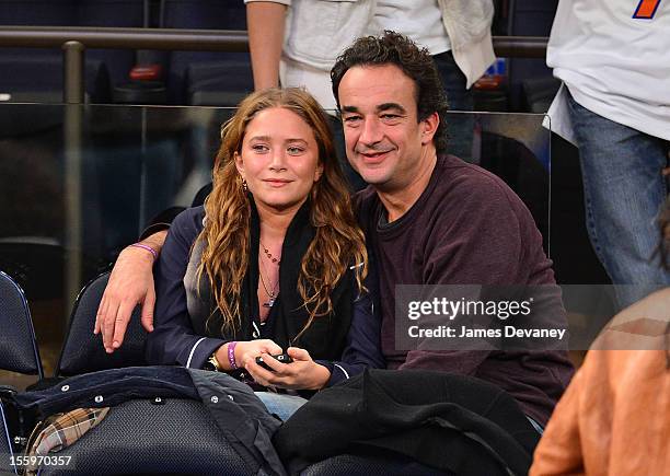 Mary-Kate Olsen and Olivier Sarkozy attend the Dallas Mavericks vs New York Knicks game at Madison Square Garden on November 9, 2012 in New York City.