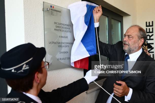 French Justice Minister Eric Dupond-Moretti unveils a plaque as he inaugurates a centre for rehabilitating former inmates in Le Pontet, near Avignon,...