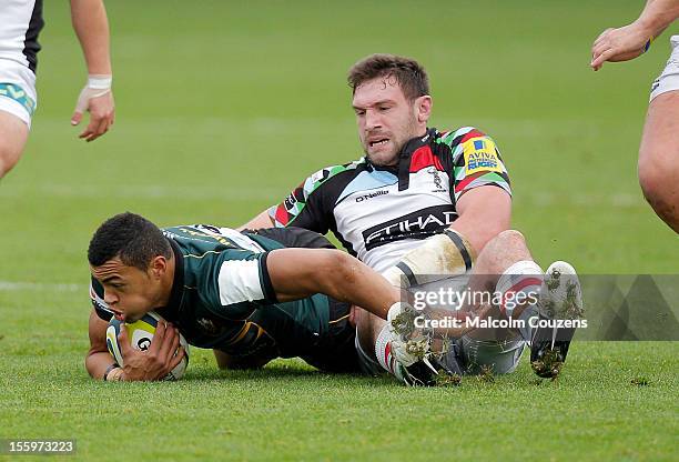 Luther Burrell of Northampton Saints is tackled by Tom Guest of Harlequins during the LV= Cup match Northampton Saints v Harlequins at Franklin's...