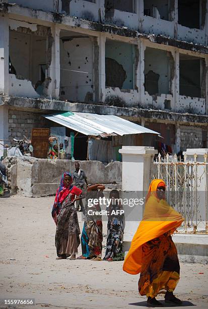 In a photo taken on November 9, 2012 and released by the African Union-United Nations Information Support team on November 10 a woman walks past...