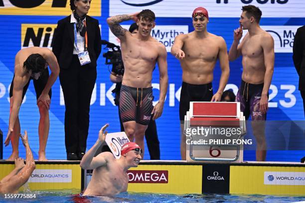 Team Britain celebrate after victory in the final of the men's 4x200m freestyle relay swimming event during the World Aquatics Championships in...