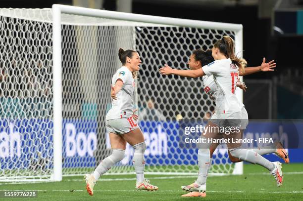Ramona Bachmann of Switzerland celebrates with teammates Coumba Sow and Seraina Piubel after scoring her team's first goal during the FIFA Women's...