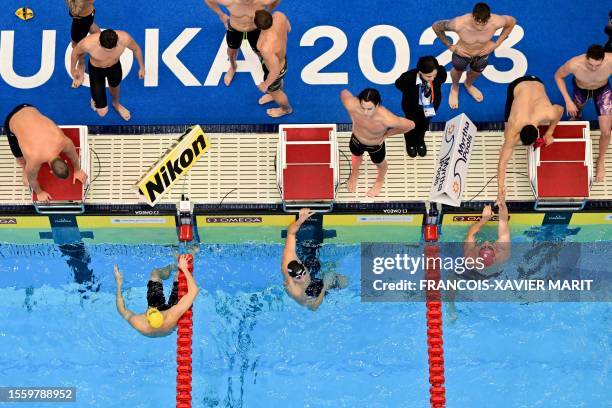 Winners team Britain and second-placed Australia react after competing in the final of the men's 4x200m freestyle relay swimming event during the...