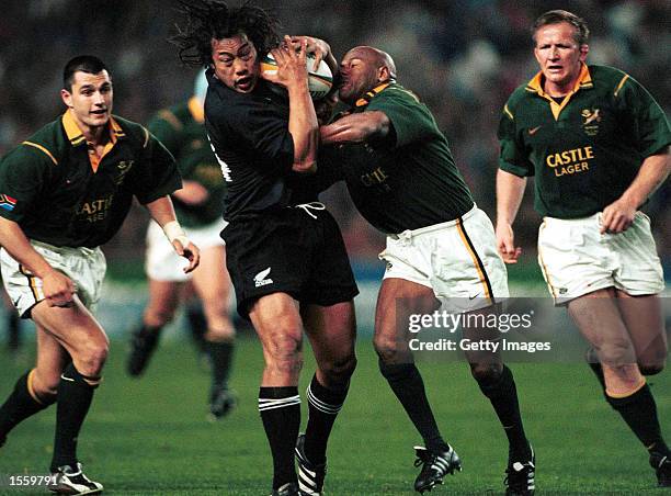 Tana Umaga of New Zealand is stopped by Chester Williams of South Africa as the South Africa Springboks defeated the New Zealand All Blacks 46-40 at...