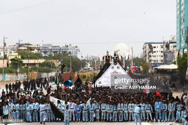 Shiite Muslims take part in a procession on the ninth day of Ashura in the Islamic month of Muharram in Karachi on July 28, 2023. Ashura is a period...