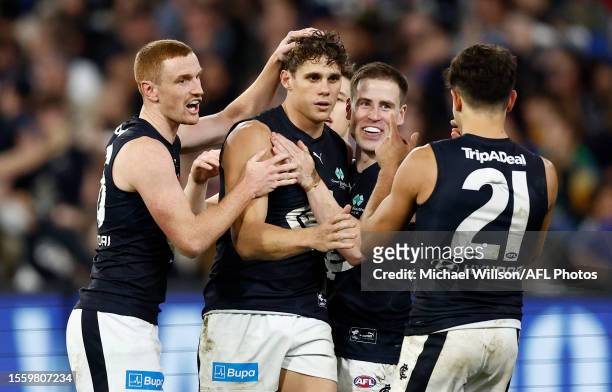 Charlie Curnow of the Blues celebrates a goal with teammates during the 2023 AFL Round 20 match between the Collingwood Magpies and the Carlton Blues...