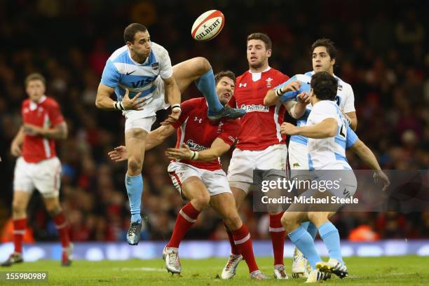 Joaquin Tuculet of Argentina spills a high ball under pressure from James Hook of Wales during the Wales versus Argentina International match at the...