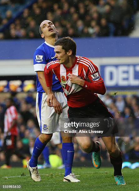 Adam Johnson of Sunderland celebrates after scoring the opening goal as Leon Osman of Everton looks on during the Barclays Premier League match...