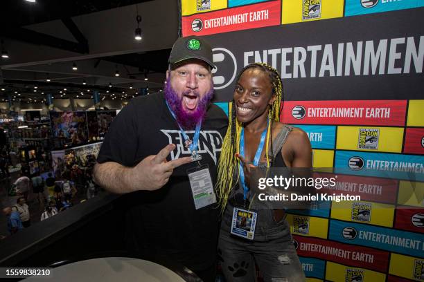 Stephen Kramer Glickman and Janeshia Adams-Ginyard poses at the Entertainment Earth booth at Comic-Con International 2023 on July 20, 2023 in San...