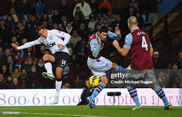 Javier Hernandez of Manchester United shoots, which subsequently rebounds off Ron Vlaar of Aston Villa for his team's second and equalising goal,...