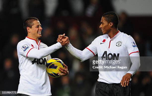 Javier Hernandez of Manchester United celebrates with team-mate Luis Antonio Valencia at the end of the Barclays Premier league match between Aston...