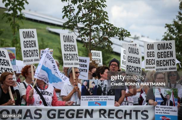 Members of the German citizen initiative "Omas gegen rechts" hold up placards during a demonstration against the 14th federal party congress of...