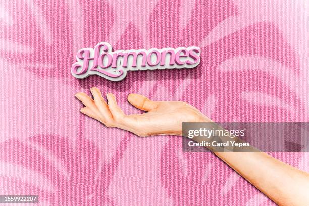 female hand holding hormones text.conceptual - hormone stock-fotos und bilder