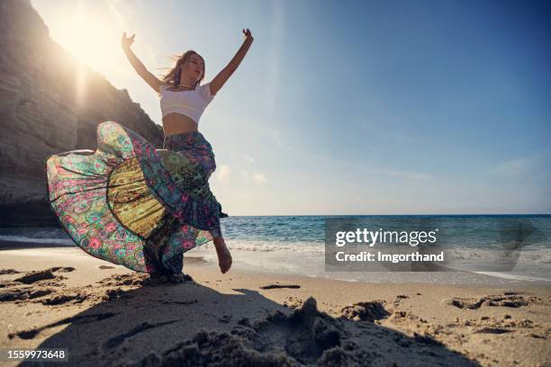 teenage girl dancing on the small beautiful beach - italian beach fun stock pictures, royalty-free photos & images