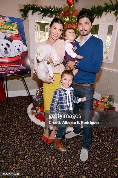 Host Ali Landry, daughter Estela, son Marcelo, and filmmaker Alejandro Gomez Monteverde attend the "Santa Paws 2: The Santa Pups" holiday party...