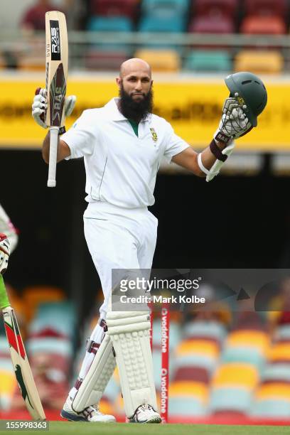 Hashim Amla of South Africa celebrates his century during day three of the First Test match between Australia and South Africa at The Gabba on...
