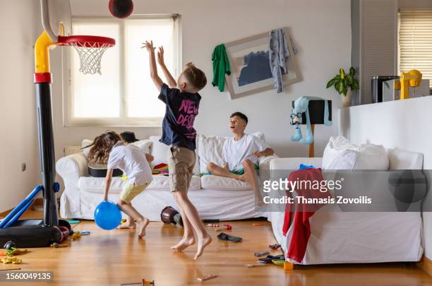 kids having fun in the living room - toy basketball hoop stock pictures, royalty-free photos & images