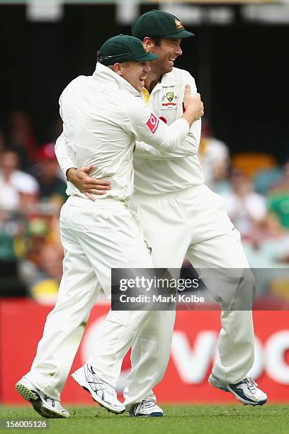 David Warner and Rob Quiney of Australia celebrate the wicket of AB De Villiers of South Africa during day three of the First Test match between...