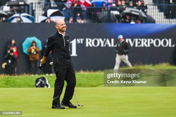 Brian Harman smiles and celebrates his six stroke victory on the 18th hole green during the final round of The 151st Open Championship at Royal...