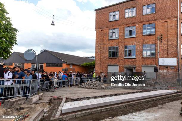 Muslims coming from Friday prayer watch the Quran being burnt on the opposite street from the mosque on July 28, 2023 in Copenhagen, Denmark. Six...