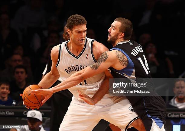 Brook Lopez of the Brooklyn Nets in action against Nikola Pekovic of the Minnesota Timberwolves at the Barclays Center on November 5, 2012 in the...