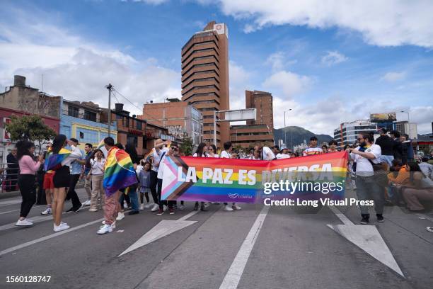 Demonstrators hold banners and pride flags during the International Pride Parade in Bogota, Colombia, July 2, 2023.
