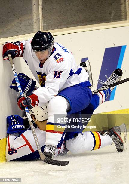 Park Woosang of South Korea is defended by Endre Kosa of Romania during the Ice Hockey Sochi Olympic Pre-Qualification Group J match between South...