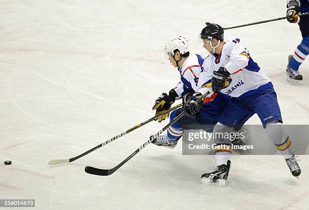 Kim Hyeok of South Korea skates against Tihamer Becze of Romania during the Ice Hockey Sochi Olympic Pre-Qualification Group J match between South...