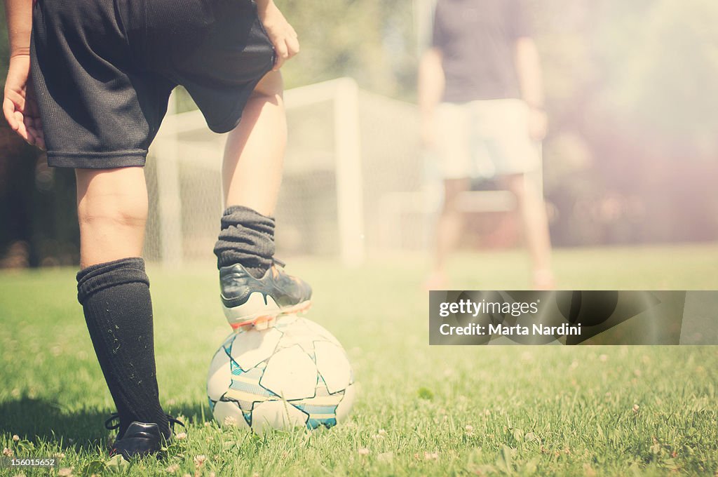 Father and son playing football