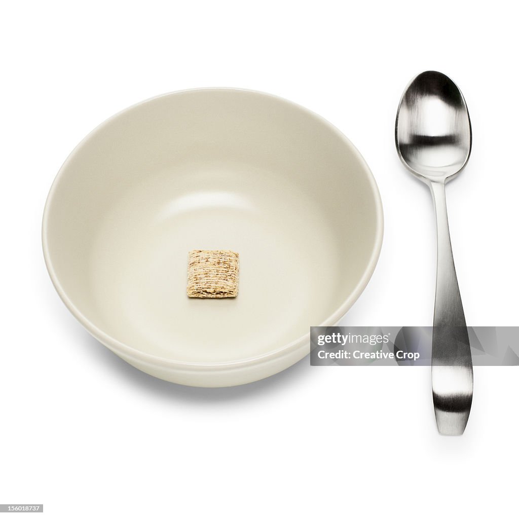 Bowl of wheat cereal and spoon