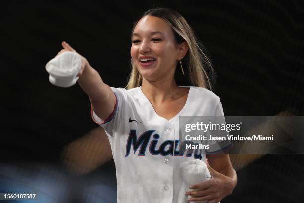 Member of the Miami Marlins Mermaids throws out t-shirts to fans in attendance of the game between the Miami Marlins and the Colorado Rockies at...