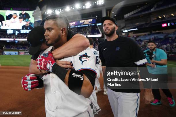 Luis Arraez of the Miami Marlins celebrates with teammates after hitting a walk off single in the 10th inning to win against the Colorado Rockies at...