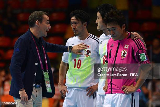 Head coach Miguel Rodrigo of Japan consoles his players Kenichiro Kogure, Kensuke Takahashi and Nobuya Osodo after loosing the FIFA Futsal World Cup...