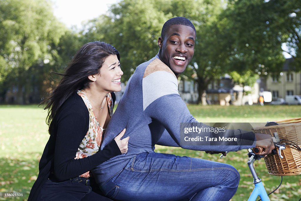 Man and woman having fun on bicycle