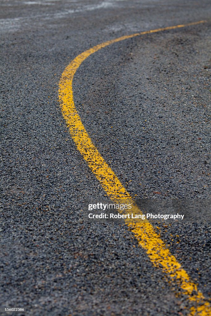 Painted yellow line marker on road