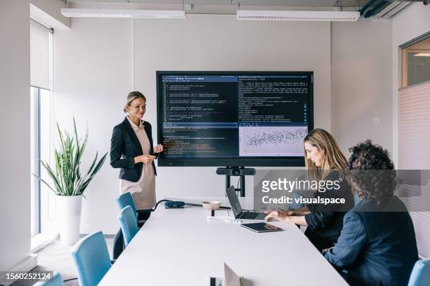 a group of software developers working together at a team meeting - code 41 stock pictures, royalty-free photos & images