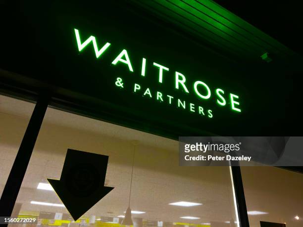 July 2023: Waitrose store sign on building exterior, store frontage.