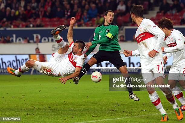 Vedad Ibisevic of Stuttgart battles for the ball with Steven Cherundolo of during the Bundesliga match between VfB Stuttgart and Hannover 96 at...