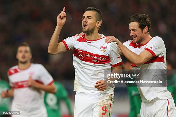 Vedad Ibisevic of Stuttgart celebrates scoring the 2nd team goal with his team mate Christian Gentner , who scores the first team goal during the...