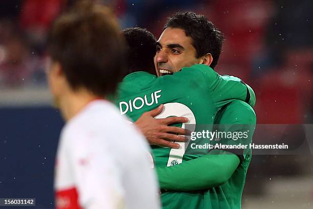 Mohammed Abdellaoue of Hannover celebrates scoring the 3rd team goal with his team mate Mame Biram Diouf during the Bundesliga match between VfB...