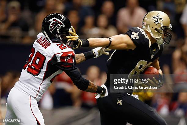 Jimmy Graham of the New Orleans Saints avoids a tackle to score a touchdown over Dominique Franks of the Atlanta Falcons at The Mercedes-Benz...