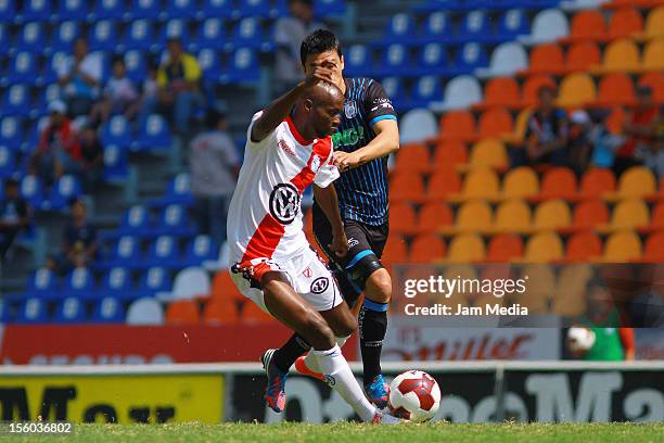 Duvier Riascos of Puebla struggles for the ball with Gonzalo Pineda of Queretaro during a match between Puebla and Queretaro as part of the Apertura...